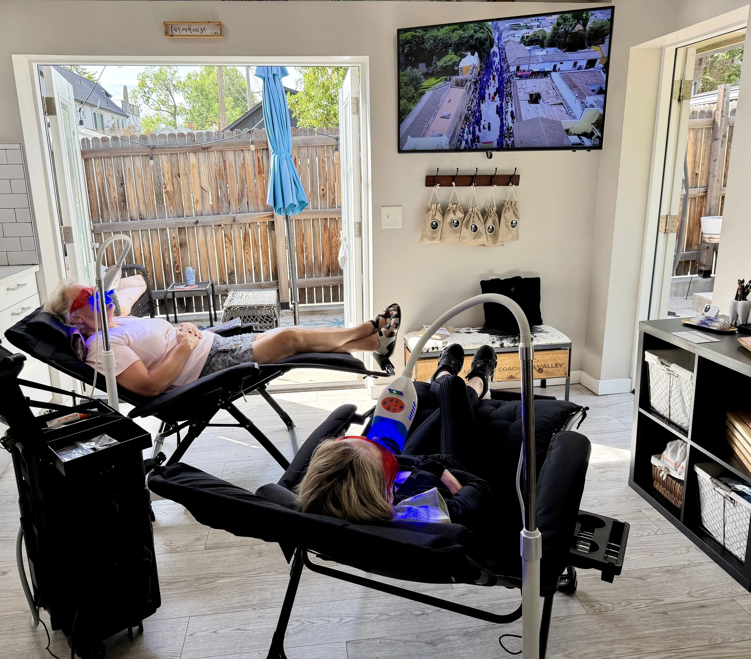 Patient relaxing at our whitening studio, watching TV while getting her teeth whitened in all comfort.