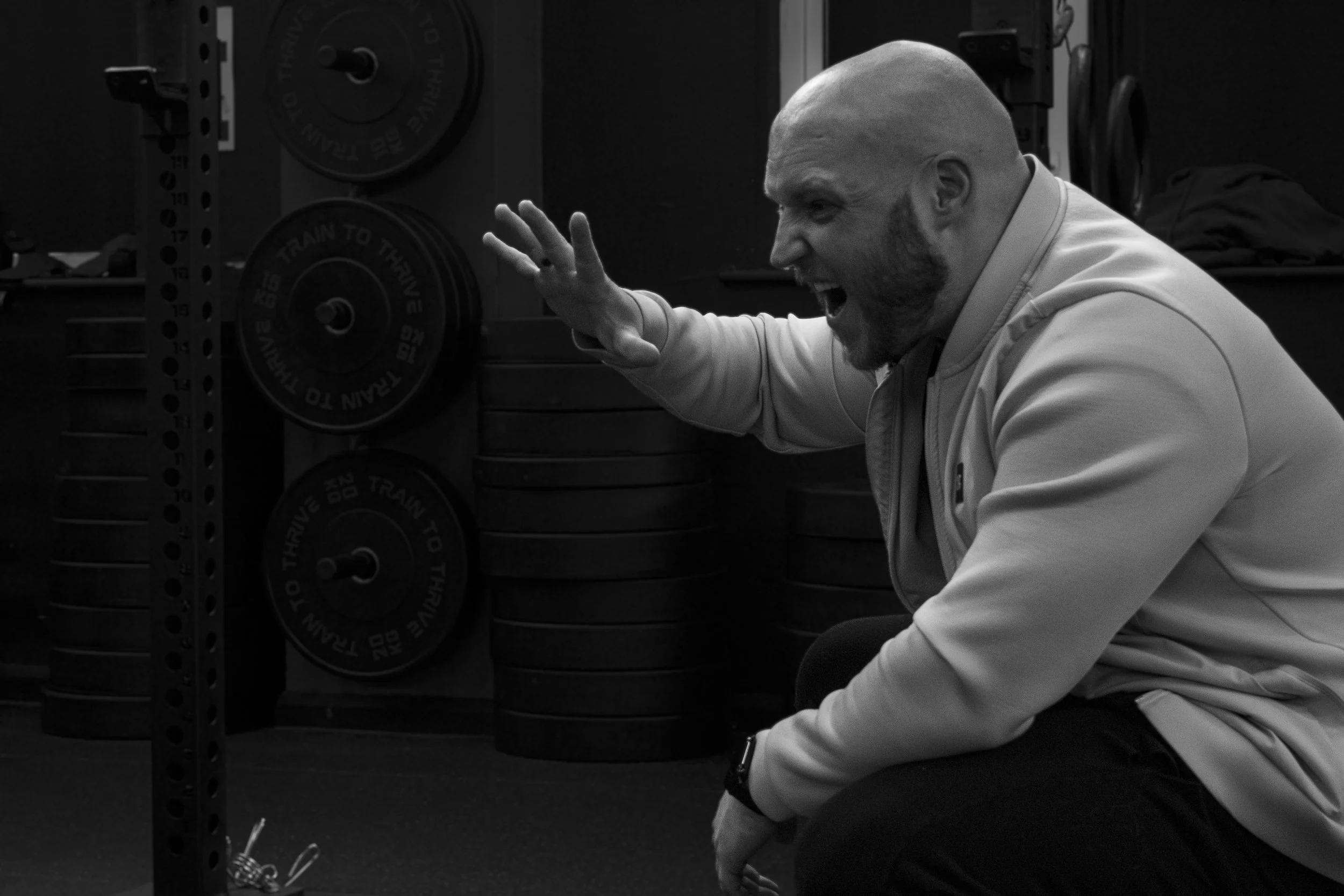 Mateusz Rys from MMR Fitness coaching a beginner through a simple exercise