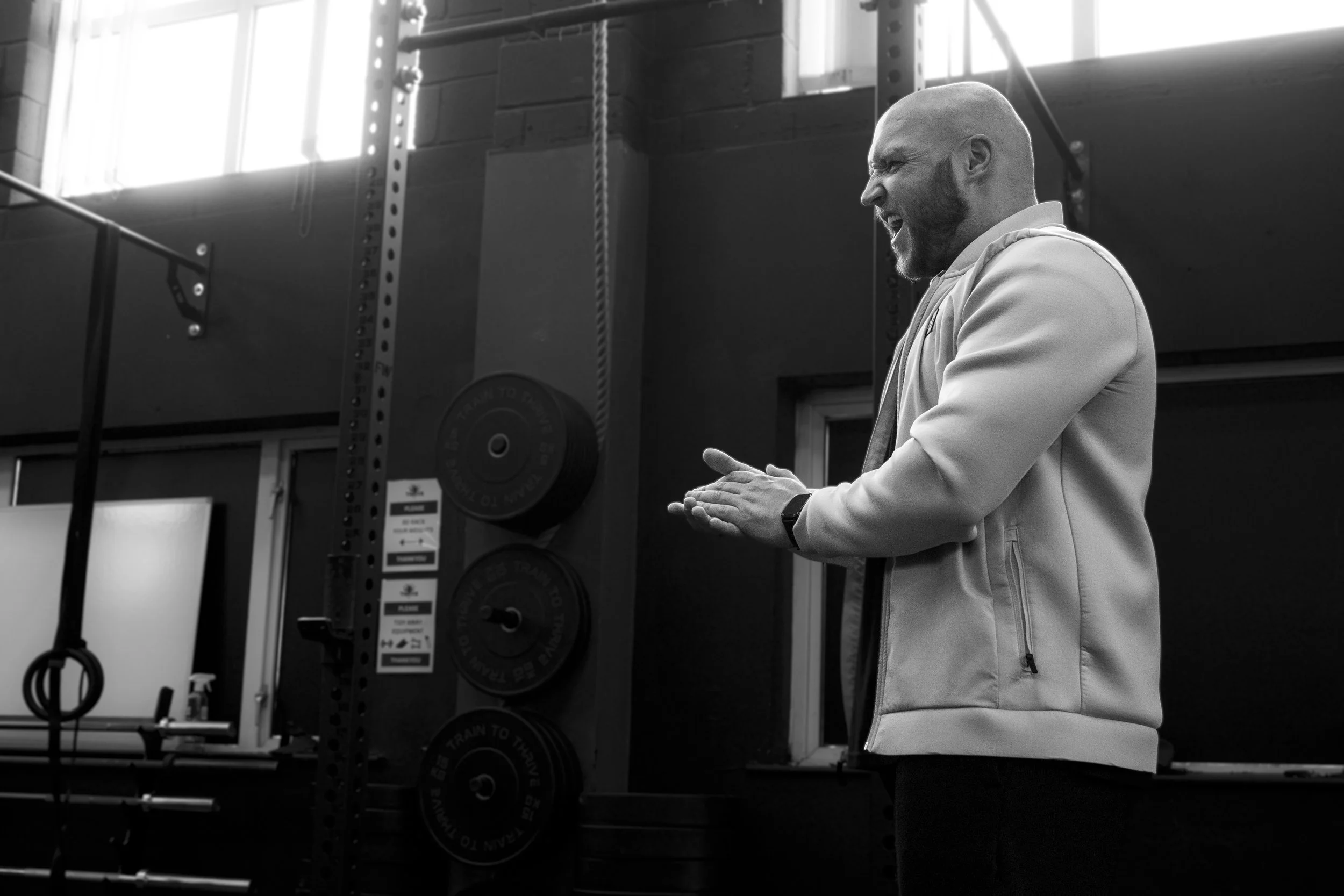 Mateusz Rys clapping and encouraging people during a group training session in Carlisle