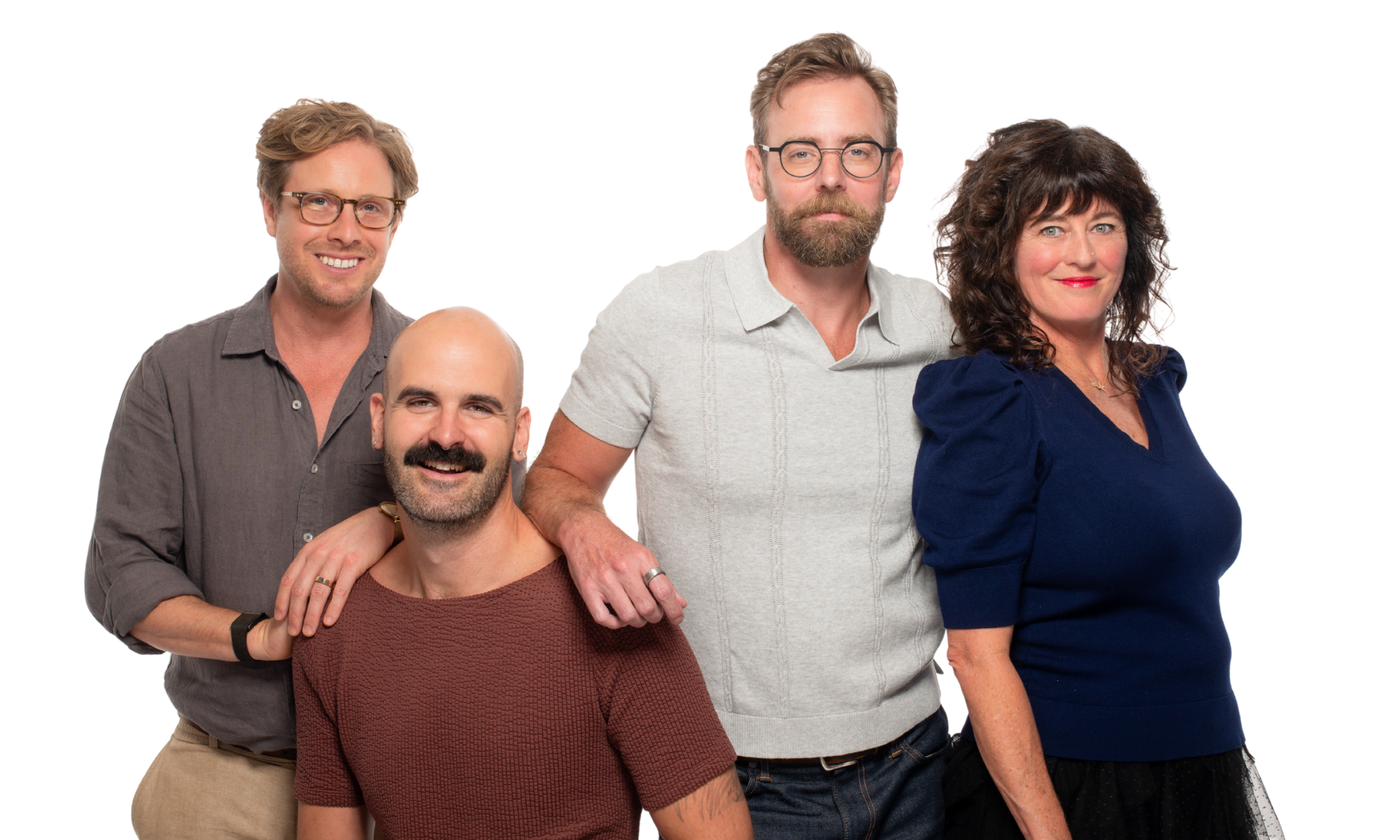 A team of warm, friendly professionals poses for a photo together.