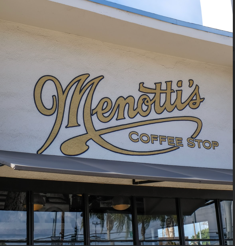Sign for Menotti's Coffee Stop on the exterior of a building.