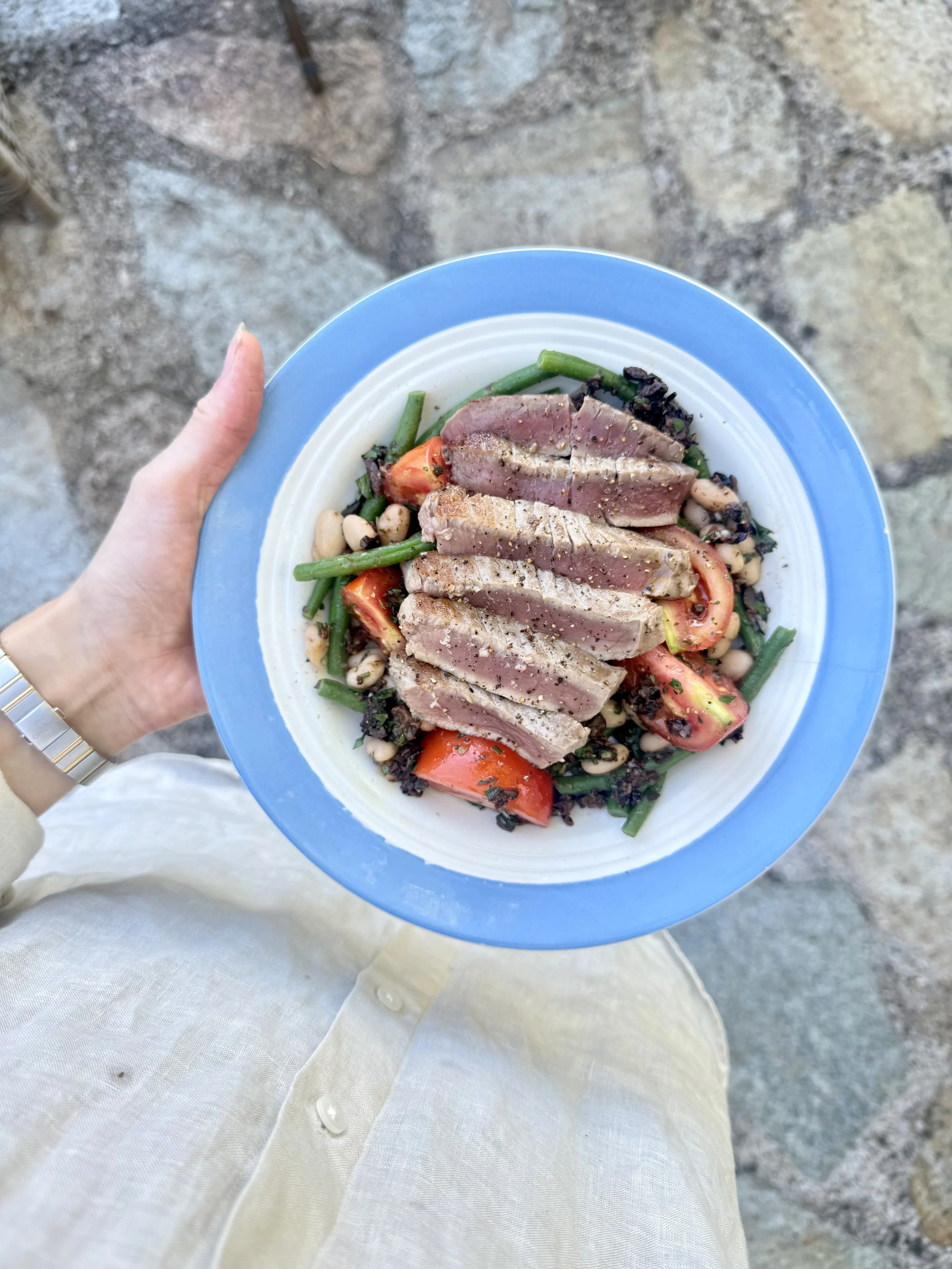 Seared tuna steak with a tomato, green bean, white bean and olive salad.