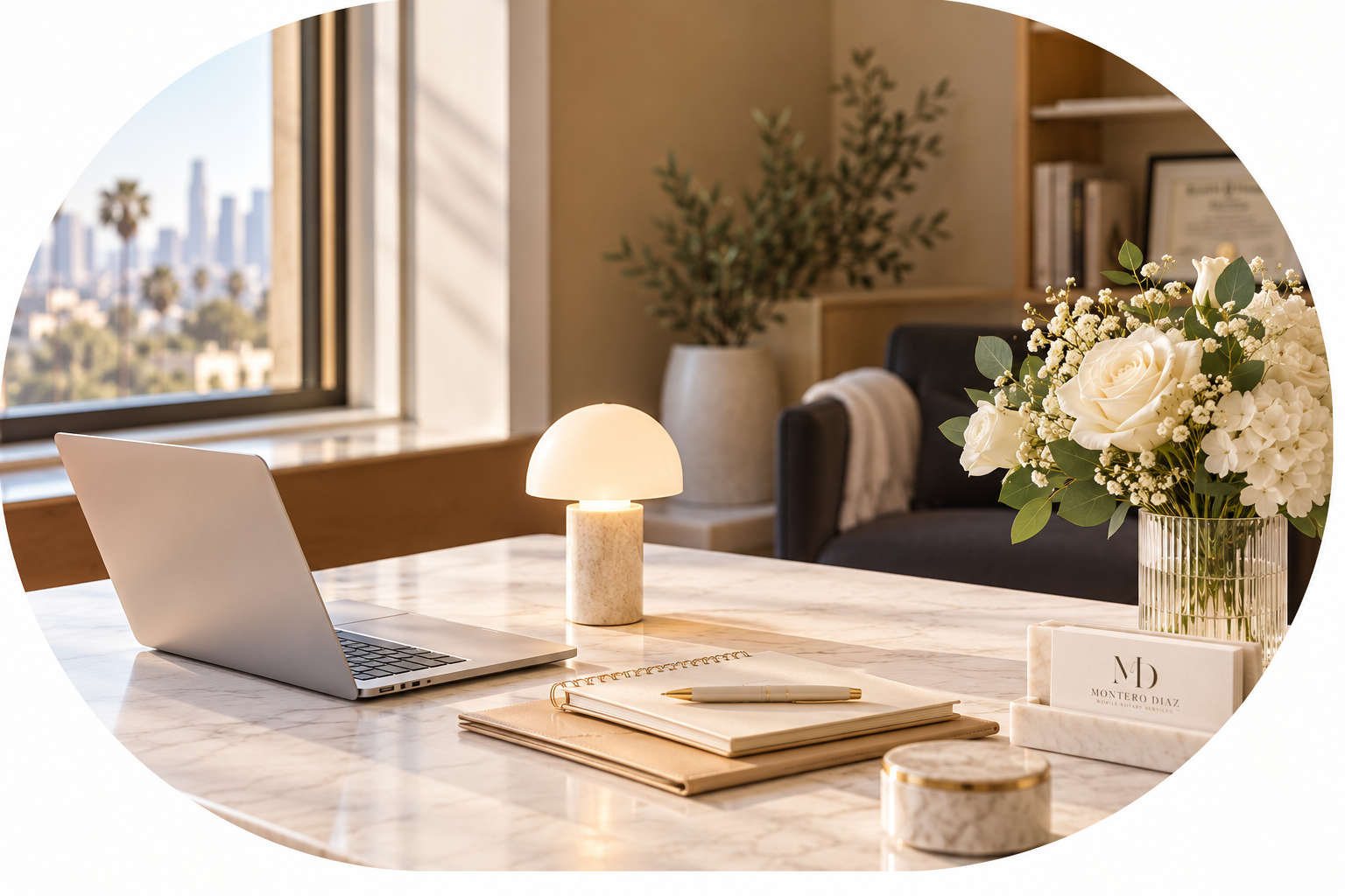 Elegant workspace for Montero Diaz Mobile Notary Services, featuring a marble desk, laptop, notebook, white flowers, and warm natural light.