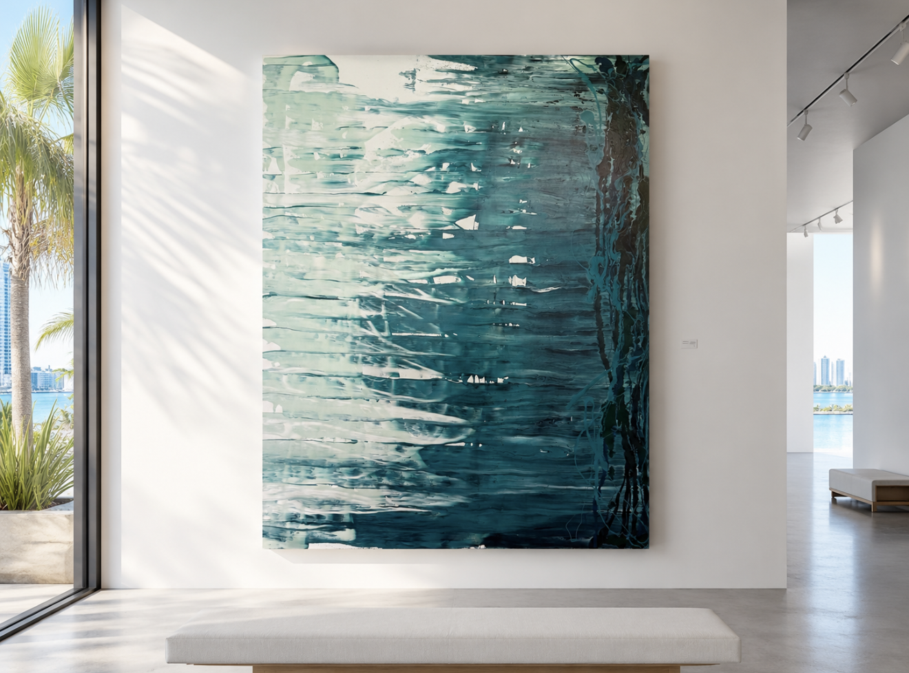 Large abstract painting resembling water with shades of blue, white, and hints of dark colors in a modern gallery space near windows with natural light.