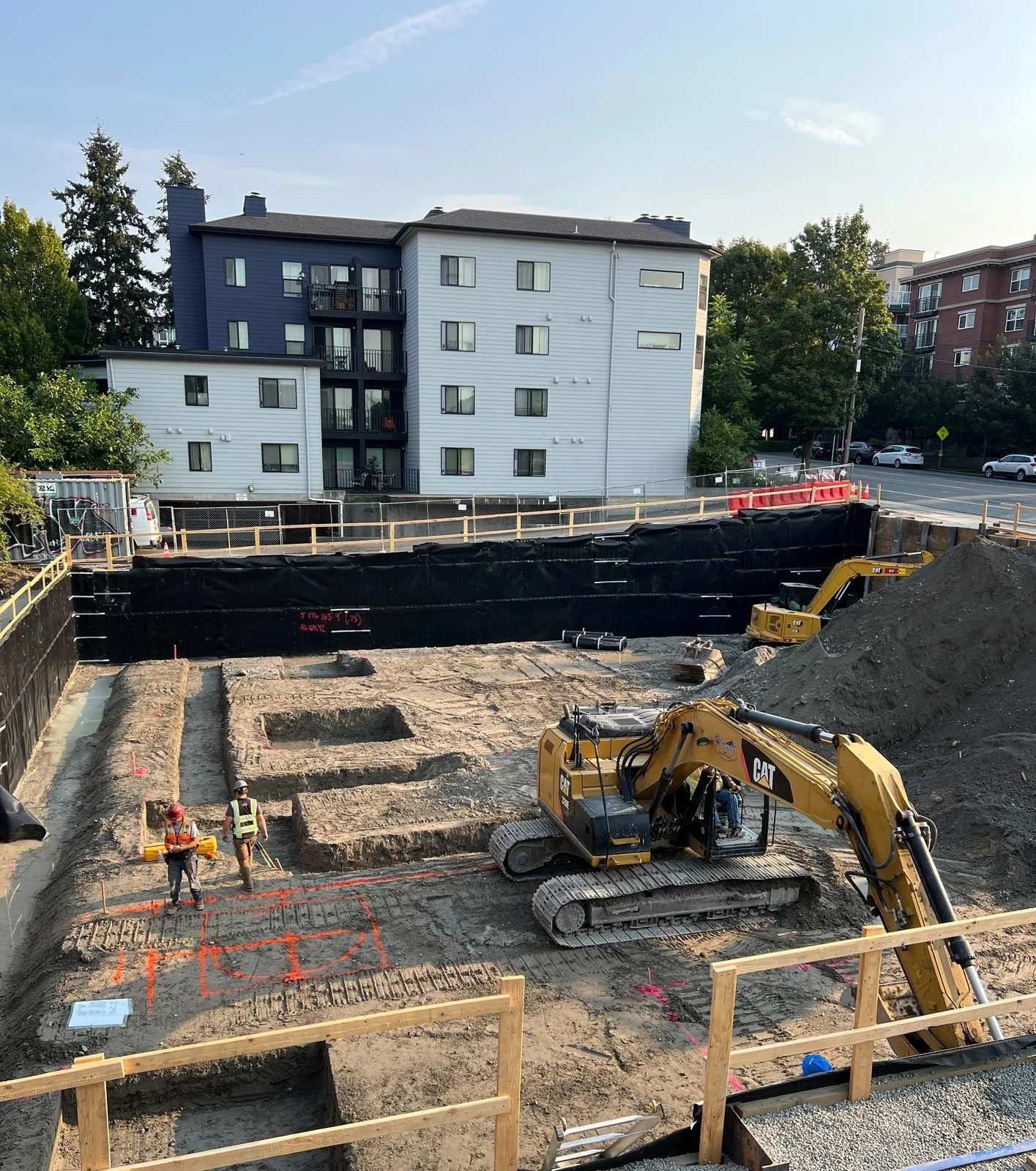 Zero-lot-line excavation and footing layout for a Seattle multifamily garage