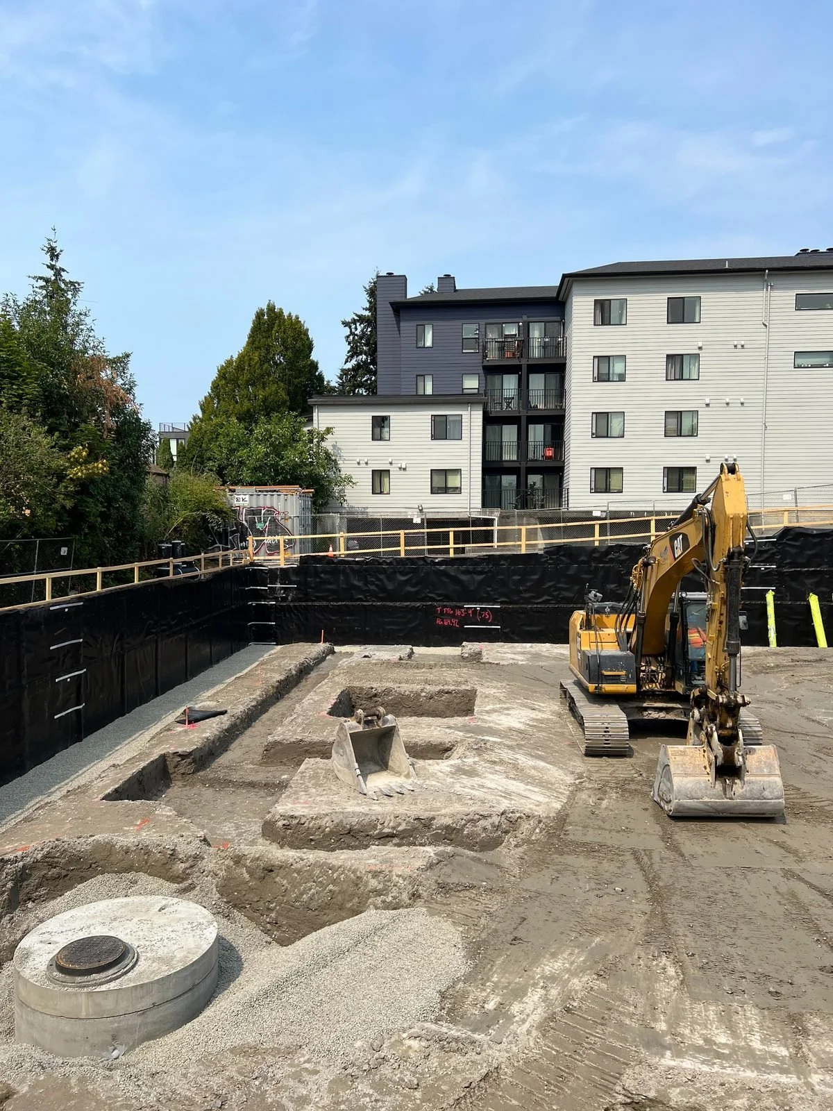 Shored multifamily excavation with underground layout in progress