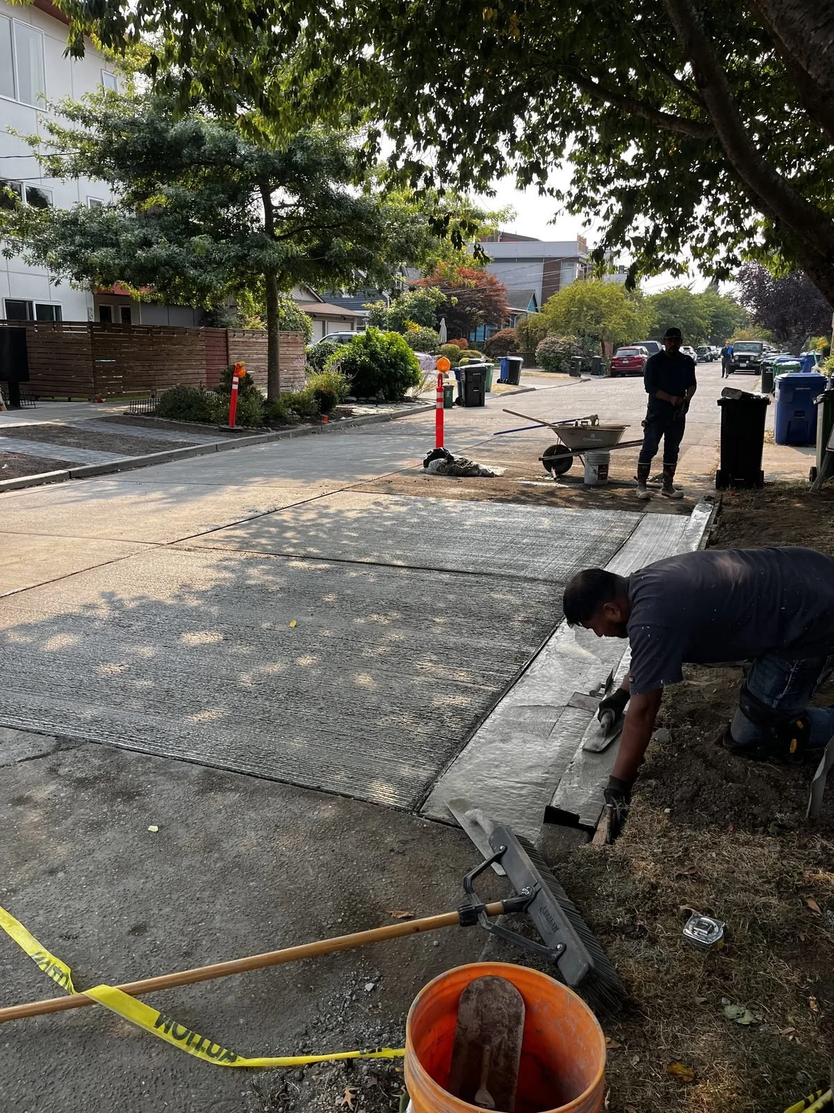 Crew finishing a new full-depth concrete street panel