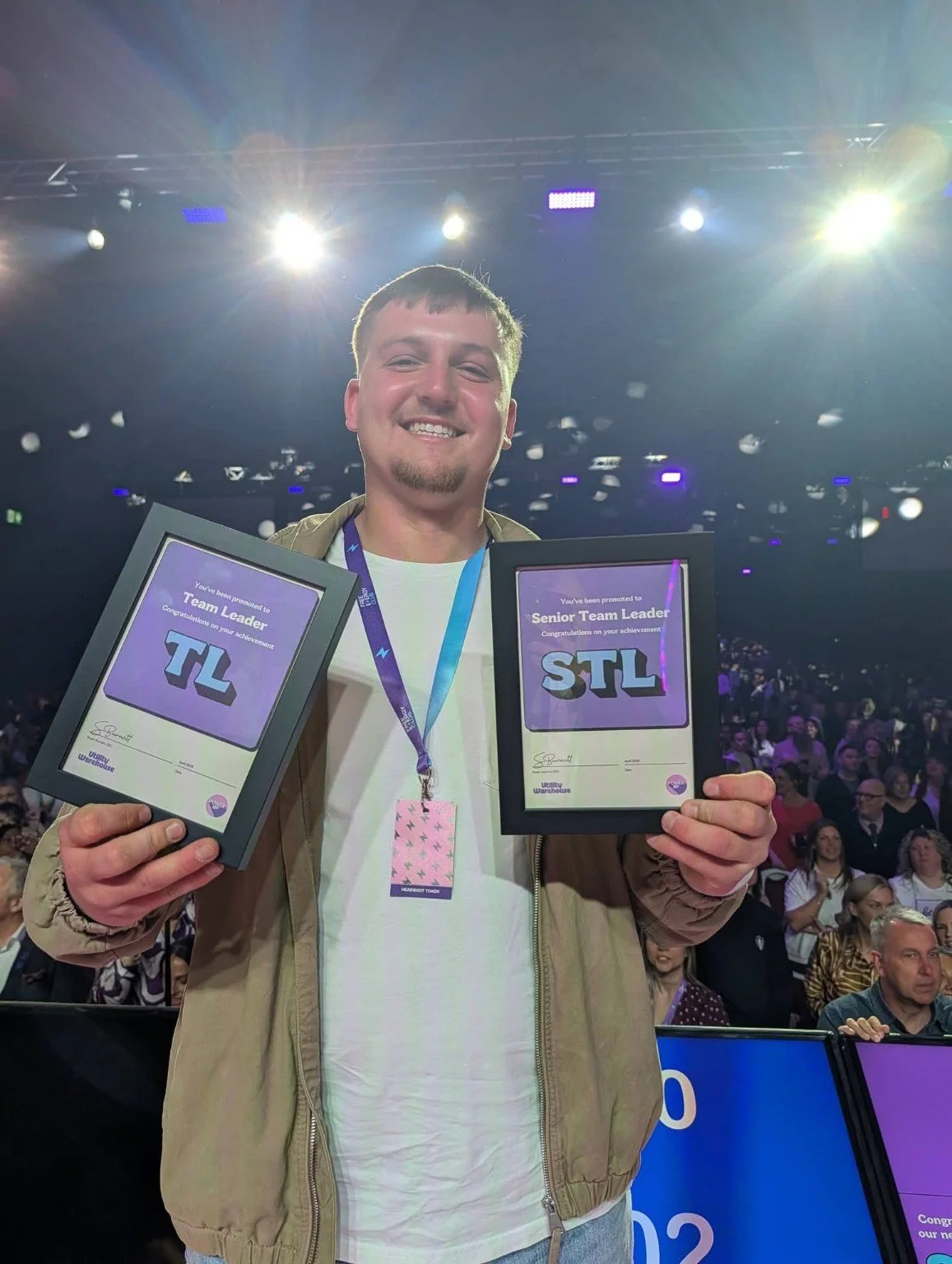 Kai Oloughlin holding Team Leader and Senior Team Leader achievement awards