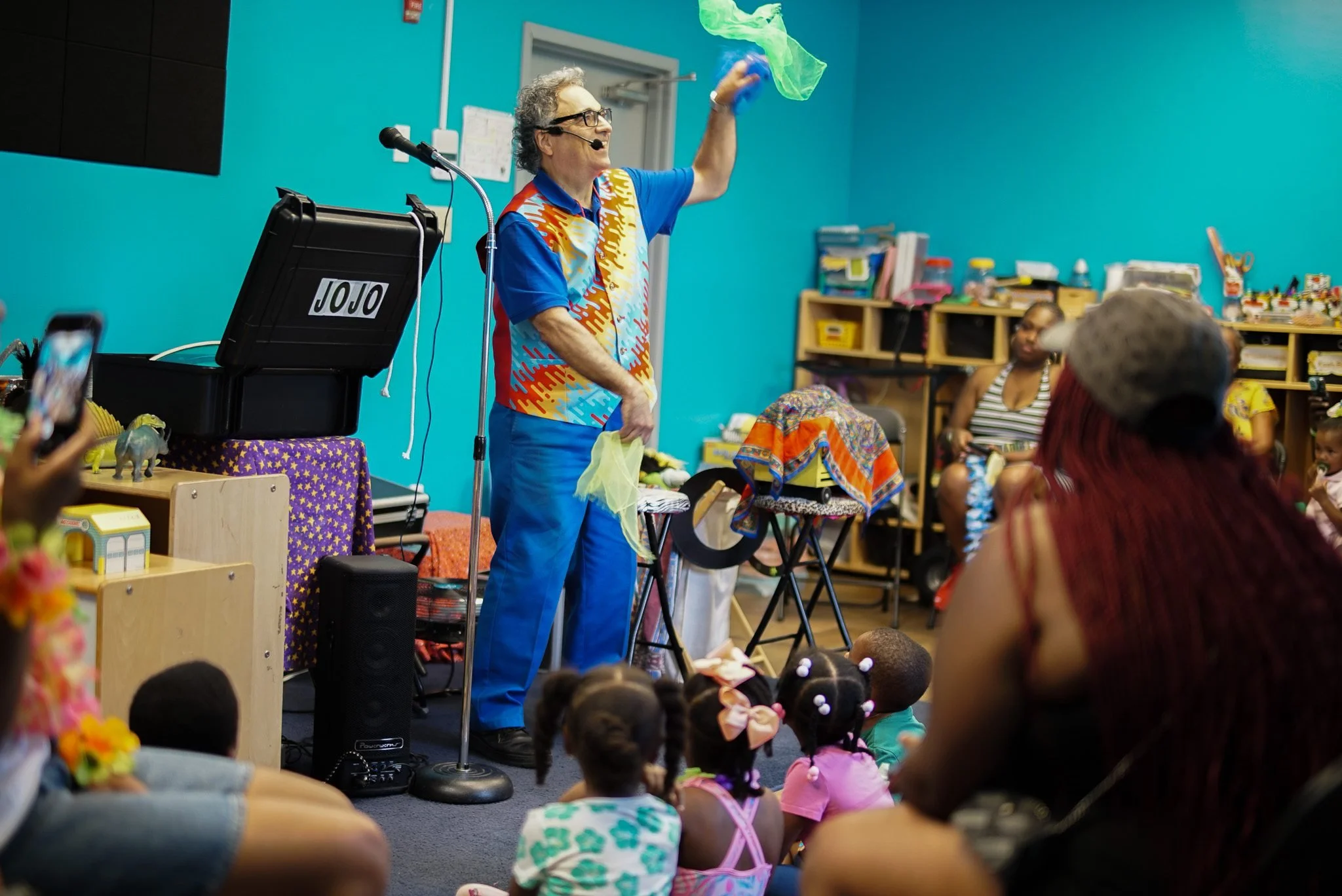 Magician performing for a classroom of children at Toddler’s University as the children watch attentively.