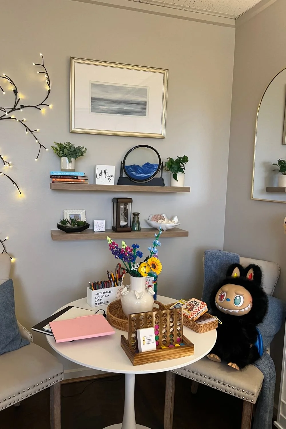 Child therapy office decorated with a vase of colorful flowers, games, and stationery.