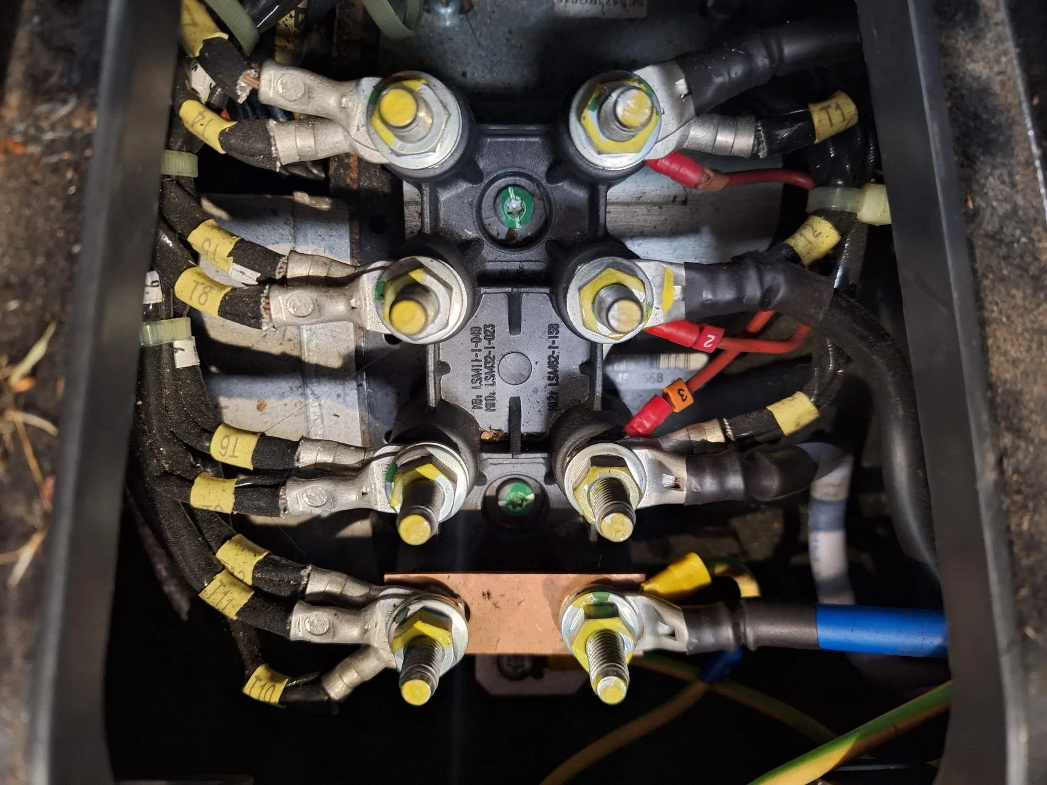 Generator cable terminals with labelled power connections inside an enclosure