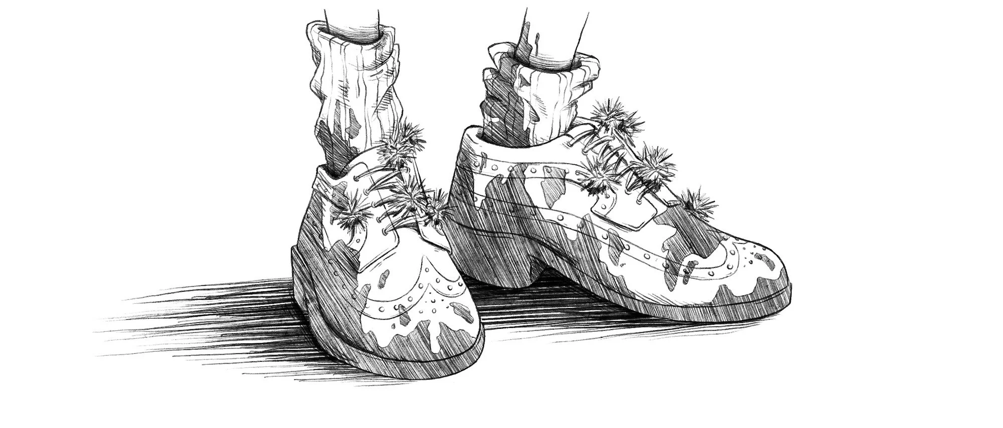 Sketch of a pair of shoes with camouflage pattern and flowers, positioned on a wooden surface.
