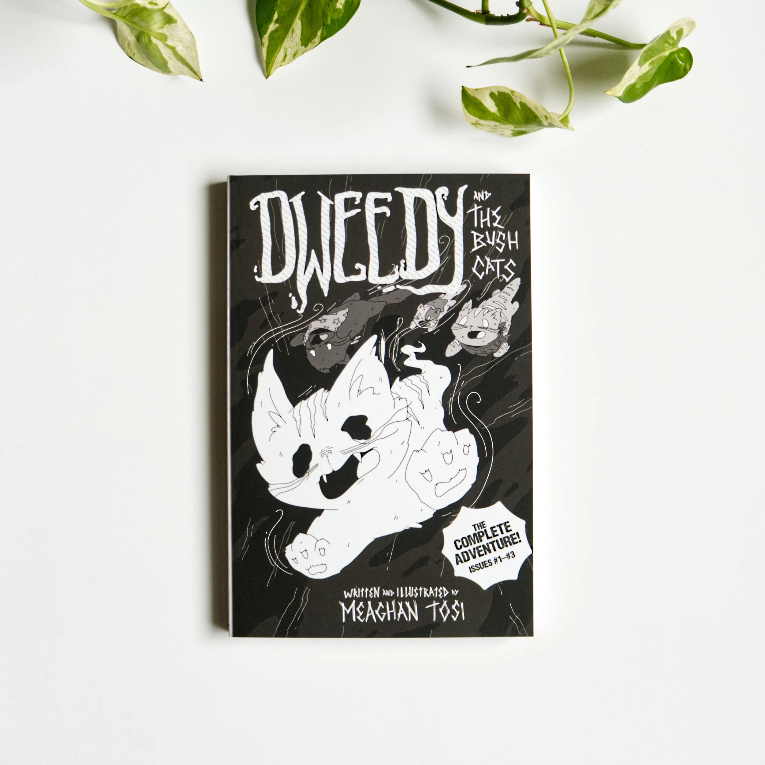 Book cover titled 'The Complete Adventure! Issues #1-#3' with black and white illustration of a wolf howling, surrounded by swirling lines and symbols, and green variegated leaves on a white background.