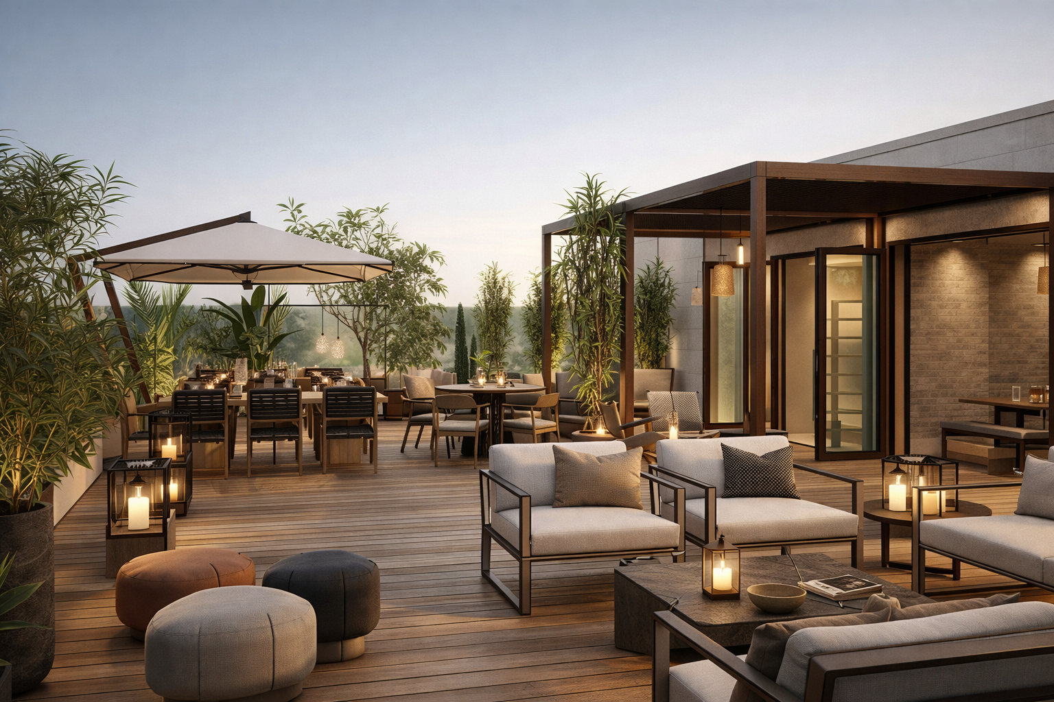 An outdoor rooftop lounge area with seating, tables, potted plants, candles, and a large umbrella during sunset.