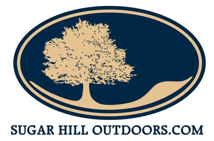 Sugar Hill Outdoors.com logo featuring a stylized tan tree inside a navy oval