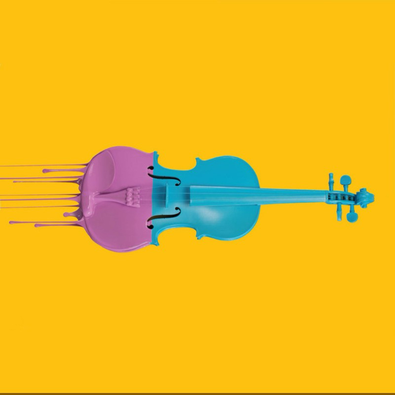 A colorful plastic violin on a yellow background.