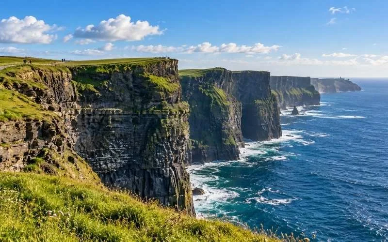 The Cliffs of Moher on Clare’s Atlantic coast offer dramatic ocean views, with towering rock faces and green clifftops stretching into the distance.