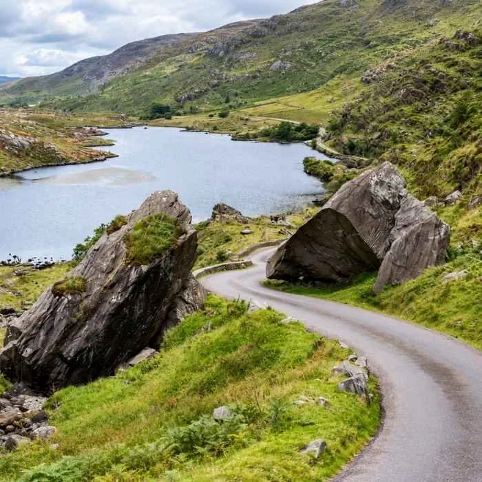 Winding road beside a mountain lake in County Kerry, illustrating our private Ring of Kerry tour.