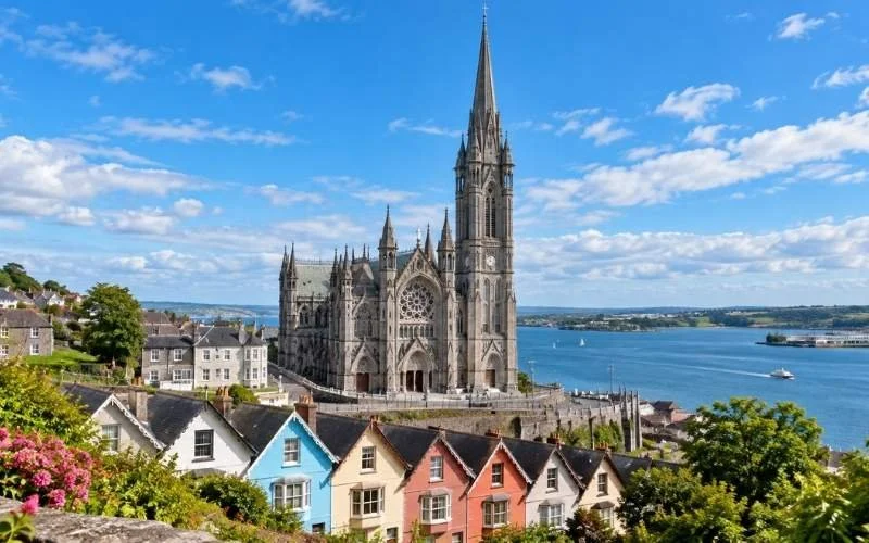 St Colman’s Cathedral rises above Cobh’s colourful streets, with intricate stonework and a distinctive spire creating a striking landmark overlooking the waters of Cork Harbour.