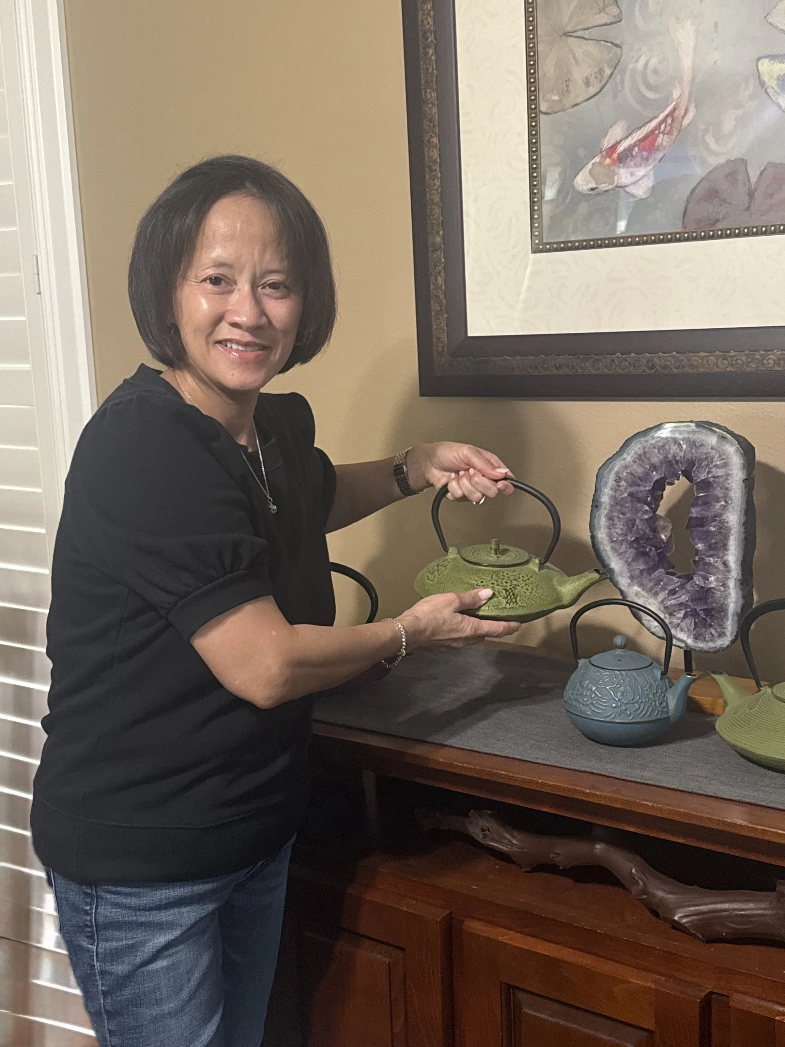 Vicki, founder and owner of Quite Organized, organizing and arranging items in a San Diego home.