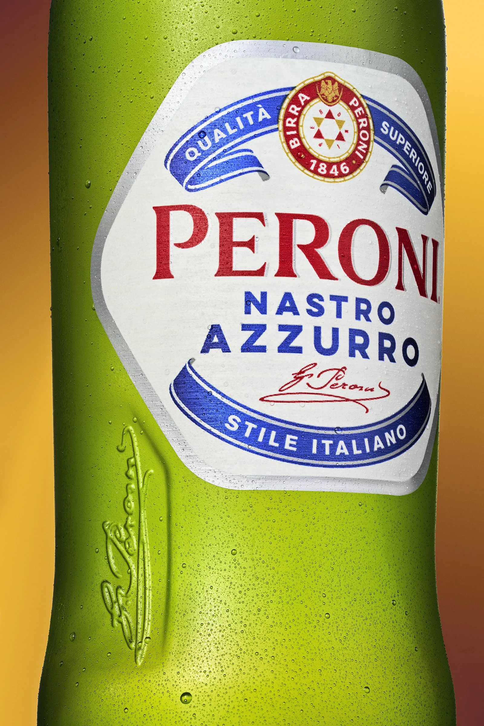 Close-up of a green Perroni Nastro Azzurro beer can with water droplets on the surface, showing the brand label with red, blue, and white details and Italian text.