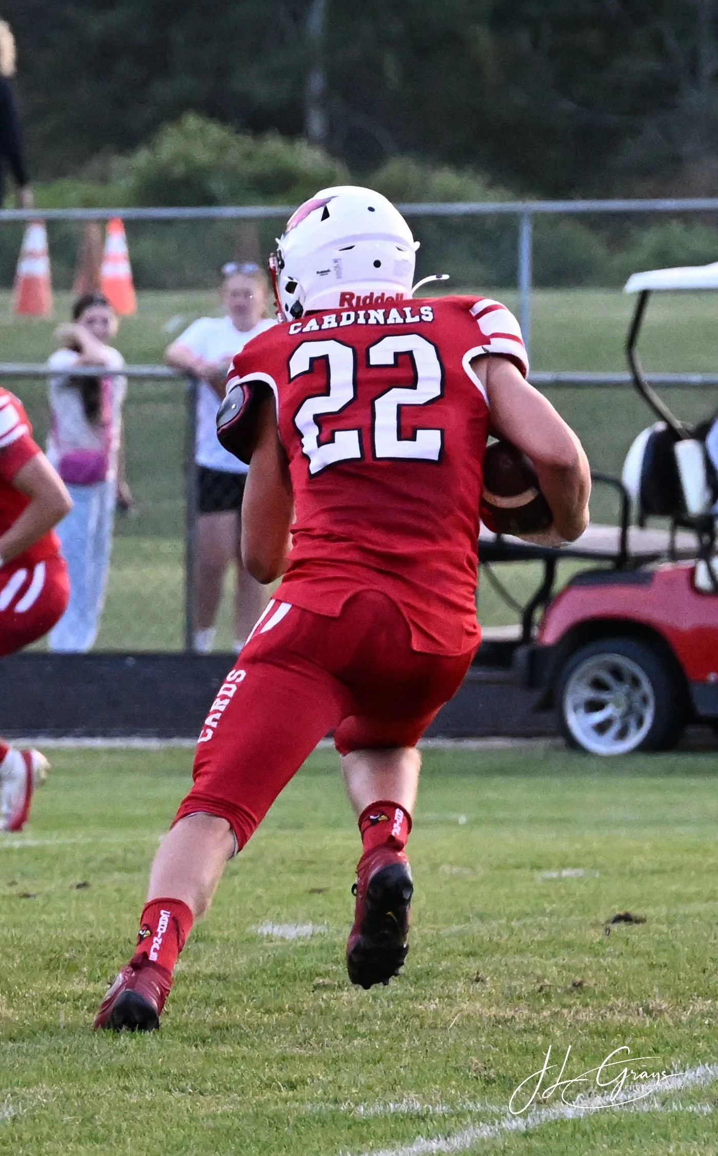 A football player wearing a red jersey with the number 22 and 