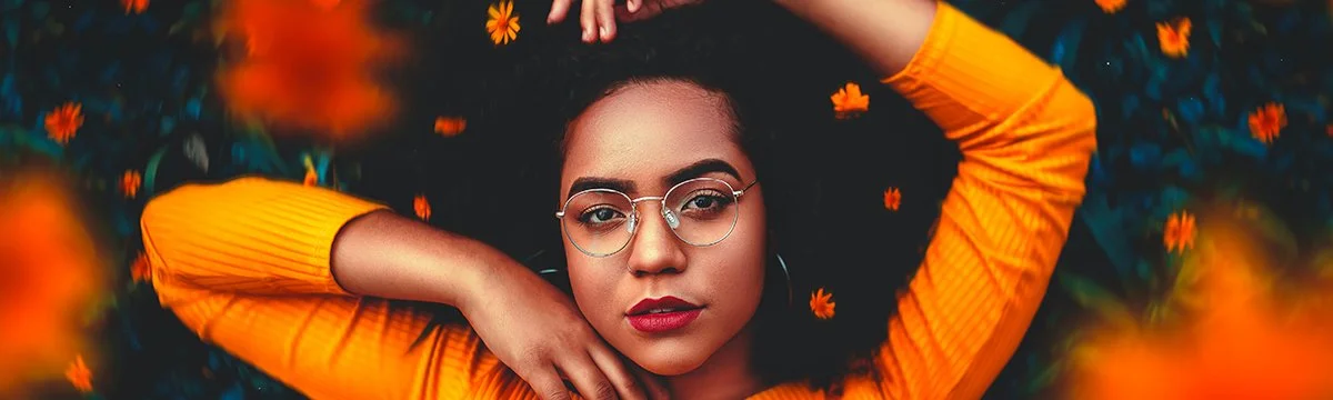 Woman relaxing outdoors surrounded by orange flowers