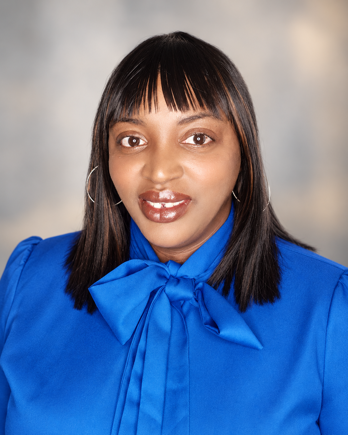 Shanetra Fowler, LCSW, founder of Making Life Add Up, smiling in a blue blouse