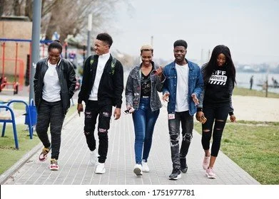 Group of five young adults walking together outdoors
