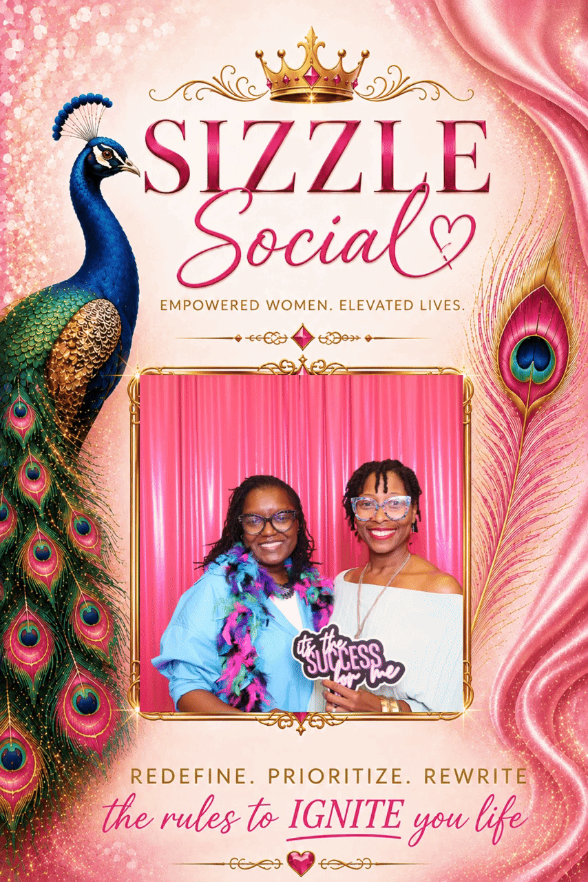 Two women smiling at a social event called Sizzle Social, with pink and gold decor, peacock feathers, and a pink curtain background, holding a sign that reads "the success is within me."