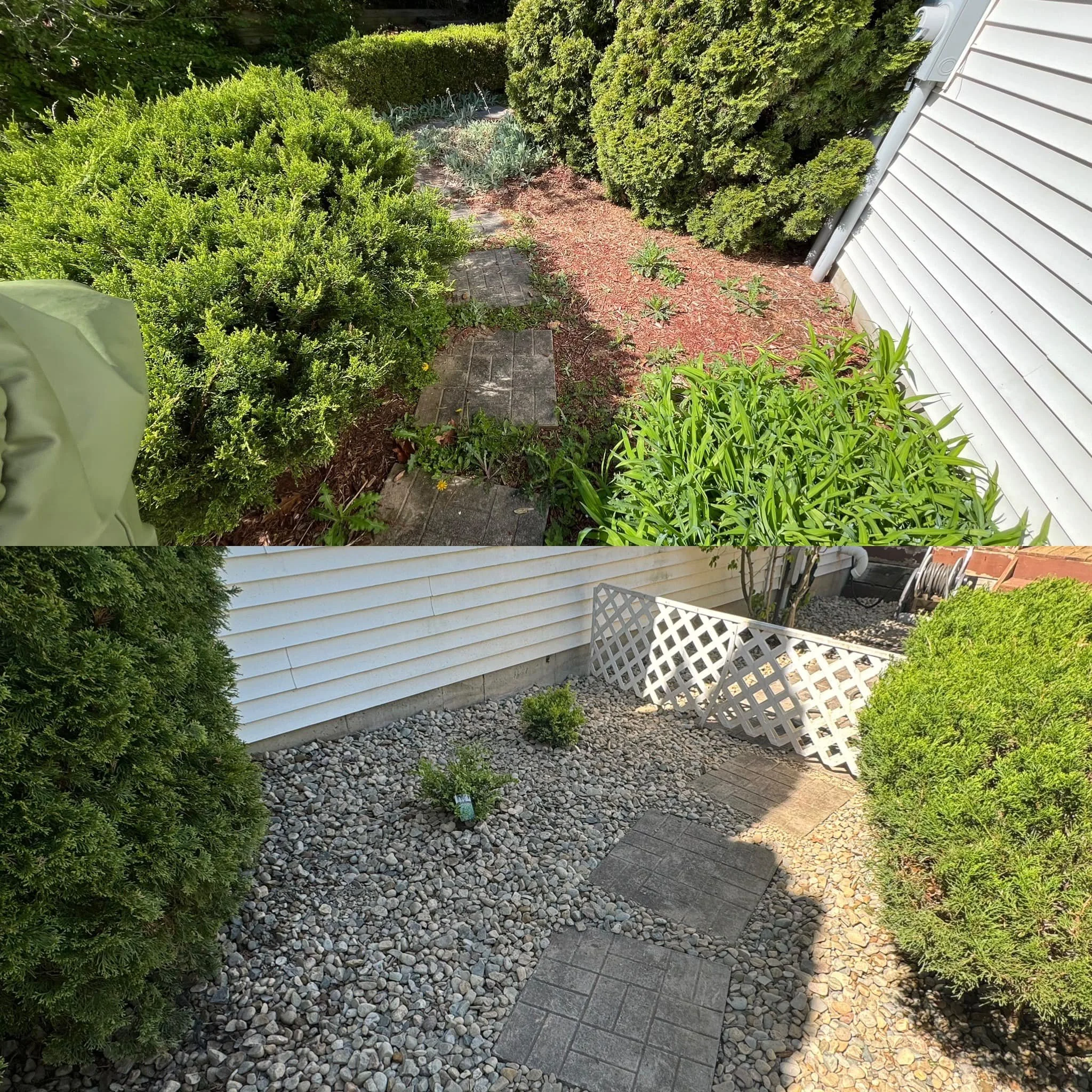 A gorgeous backyard garden with a brick pathway, green shrubs, and plants alongside a white house wall, landscaped by Traditions tree care. 