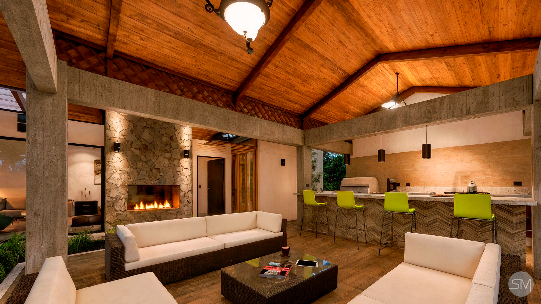 Modern living room with wooden ceiling, stone fireplace, white sofas, black coffee table, and a bar area with green chairs.