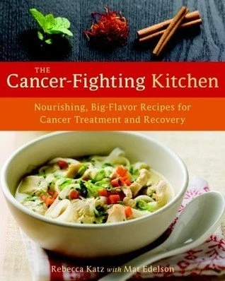 Book cover titled 'The Cancer-Fighting Kitchen' with subtitle 'Nourishing, Big-Flavor Recipes for Cancer Treatment and Recovery' by Rebecca Katz with Mat Edelson. The cover features a bowl of vegetable soup with various vegetables and pasta, placed on a red and white checkered cloth, alongside some spices and herbs.