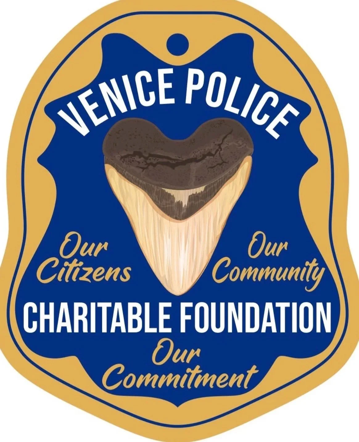 A badge or emblem with a blue and gold color scheme featuring a shark tooth and the text 'Venice Police'. It includes the phrases 'Our Citizens', 'Our Community', 'Charitable Foundation', and 'Our Commitment' indicating community support.