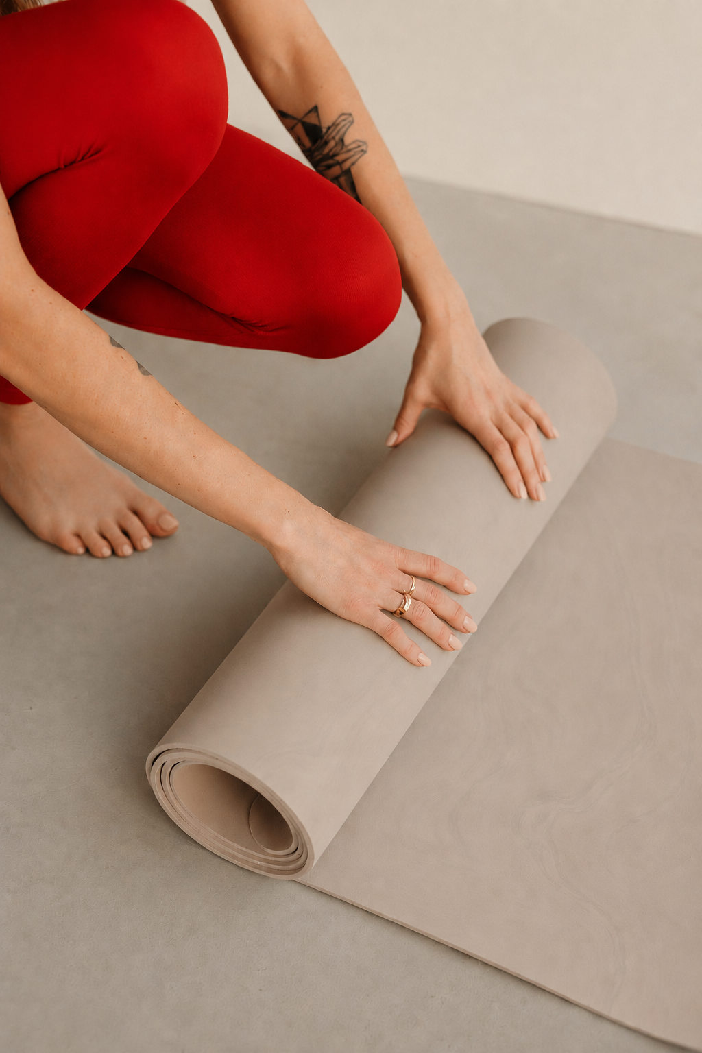 Woman setting up a mat for a Pilates class.
