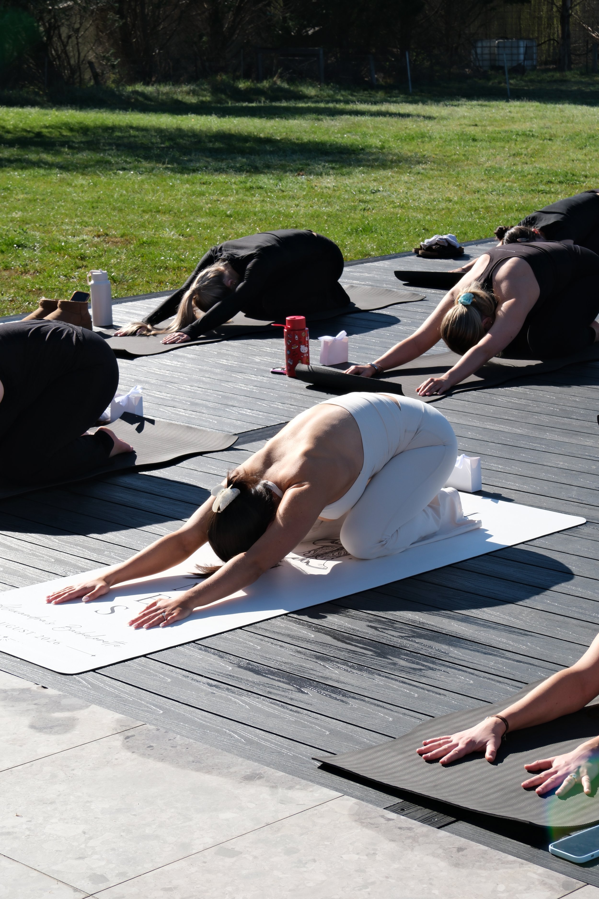 Hens party guests enjoying an outdoor Mat Pilates class in Burradoo, Southern Highlands.
