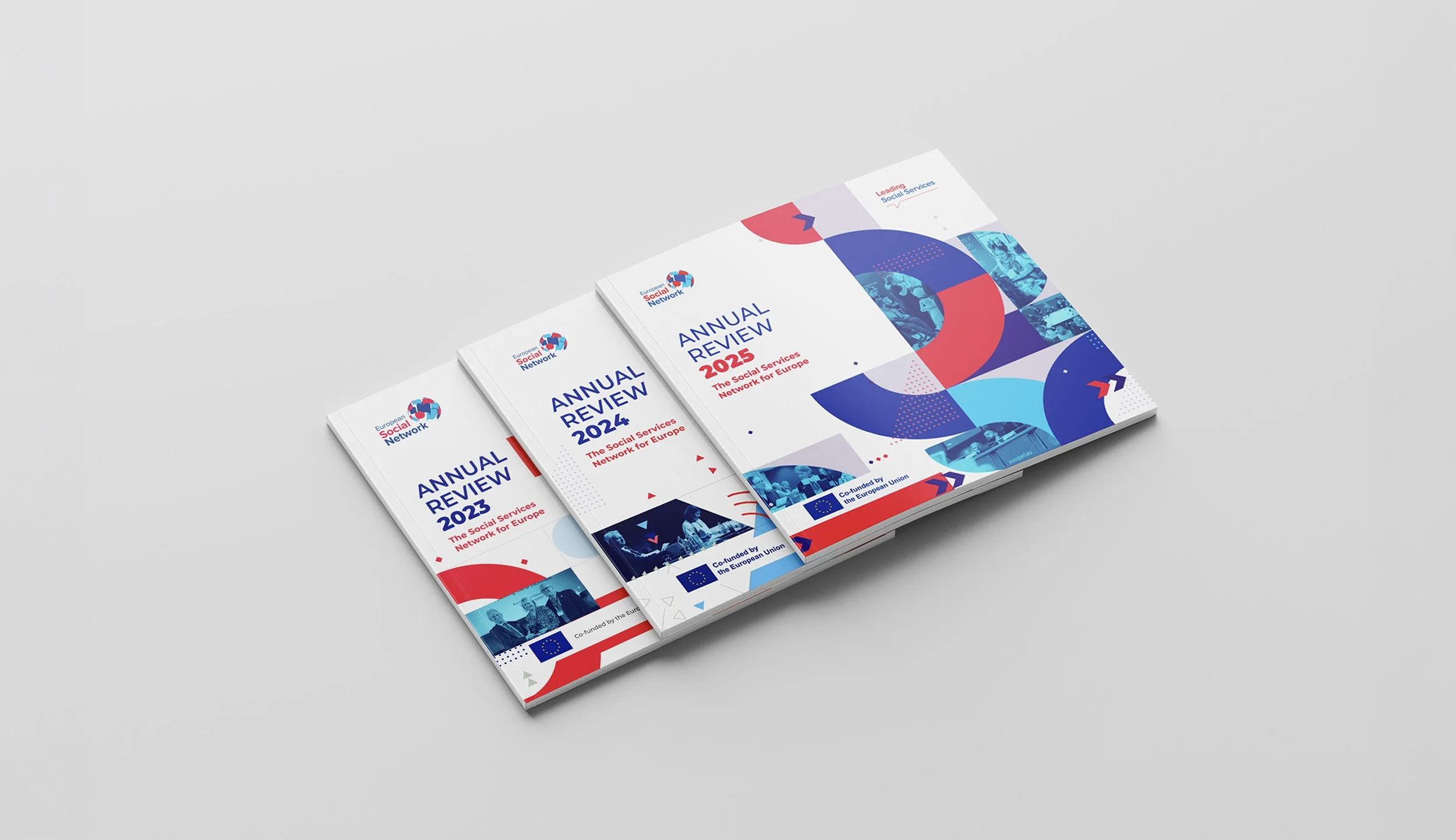 Three copies of the European Social Network annual review for 2023, 2024, and 2025, arranged on a white surface, with a colorful abstract design featuring blue, red, and purple elements.