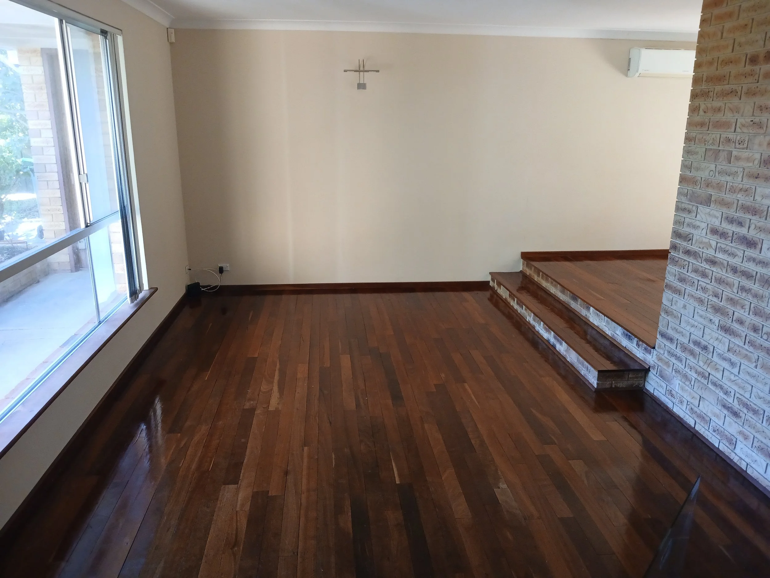 Reclaimed hardwood floor with hidden nails on concrete, after 20 years.