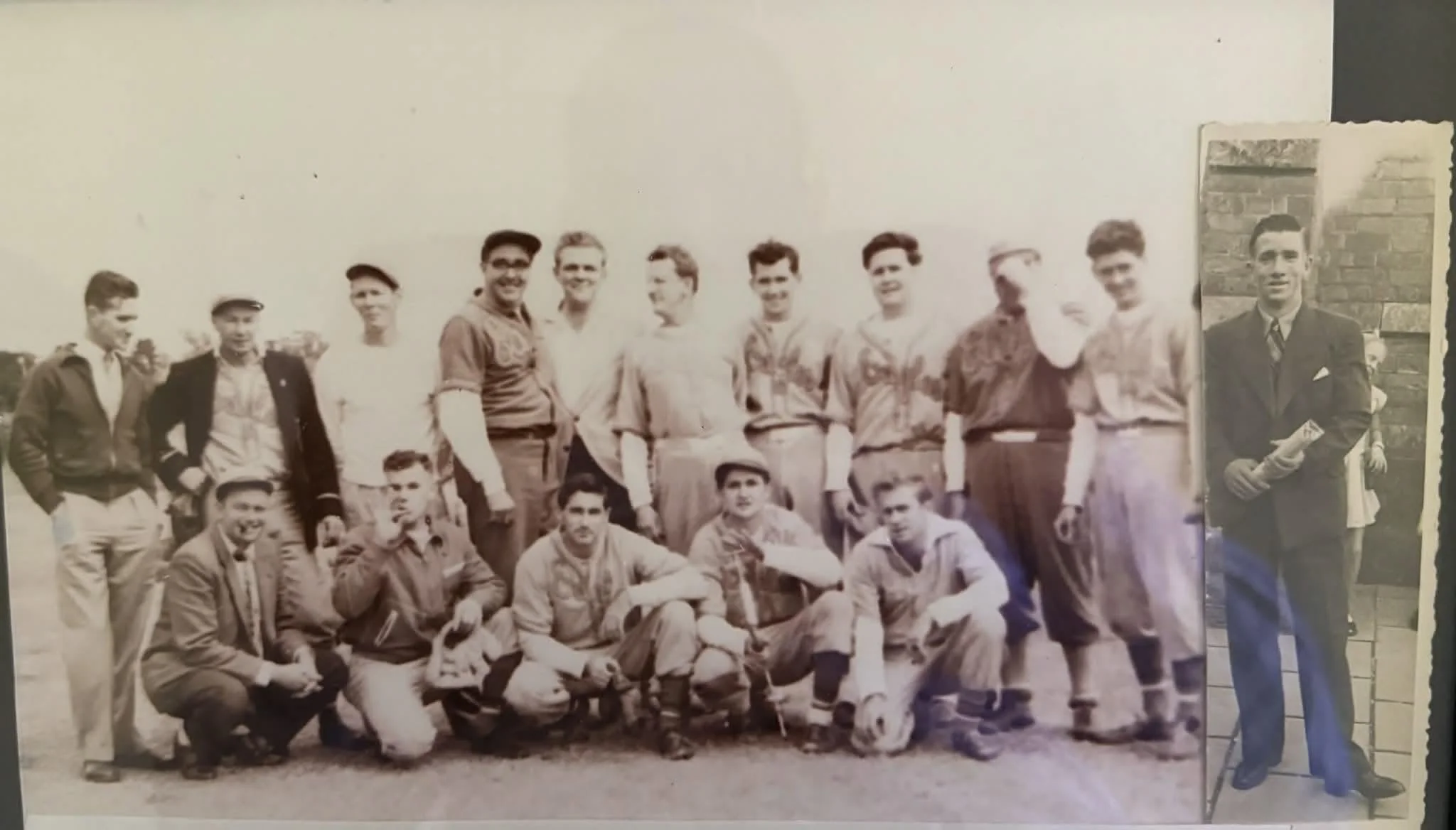 An old black-and-white photo of a group of young men and boys posing outdoors, some standing and some sitting, with a brick building in the background. A large photograph of a man in a suit is attached to the right side of the image.