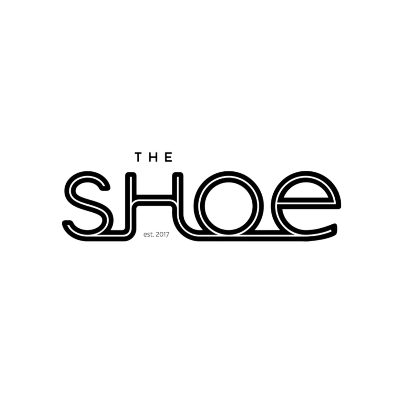 Logo for The Shoe, established in 2017, featuring a minimalist black and white design with stylized text.