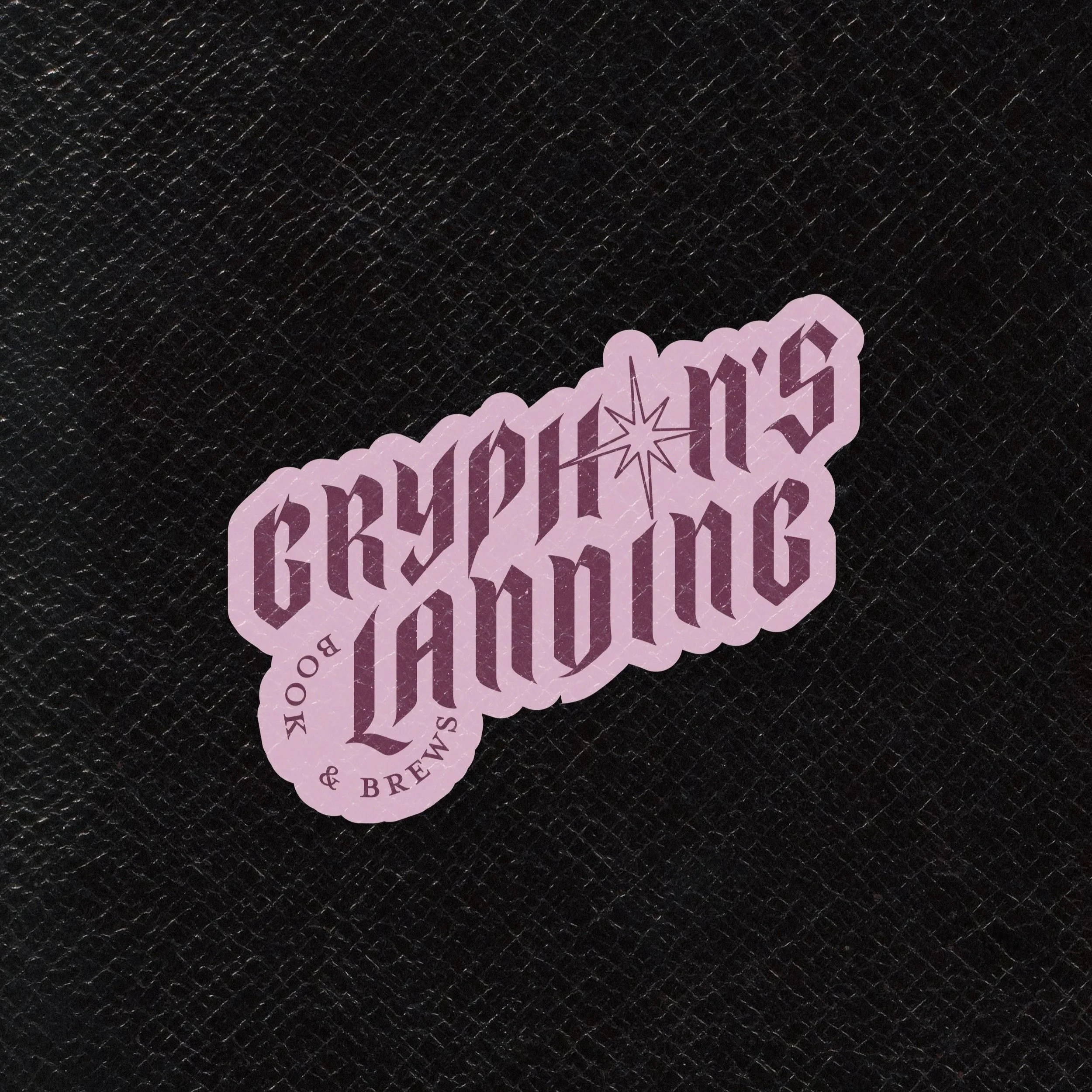 Maroon text with a lighter pink background that says "Gryphon's landing books and brews" against a black leather background. The logo is framed by two pink fantasy style swords.