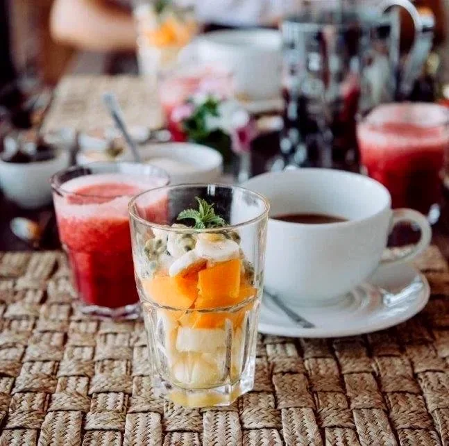 Fresh tropical fruit, coffee and colourful fruit juice served for breakfast at Lake Shore Lodge on Lake Tanganyika, Tanzania.