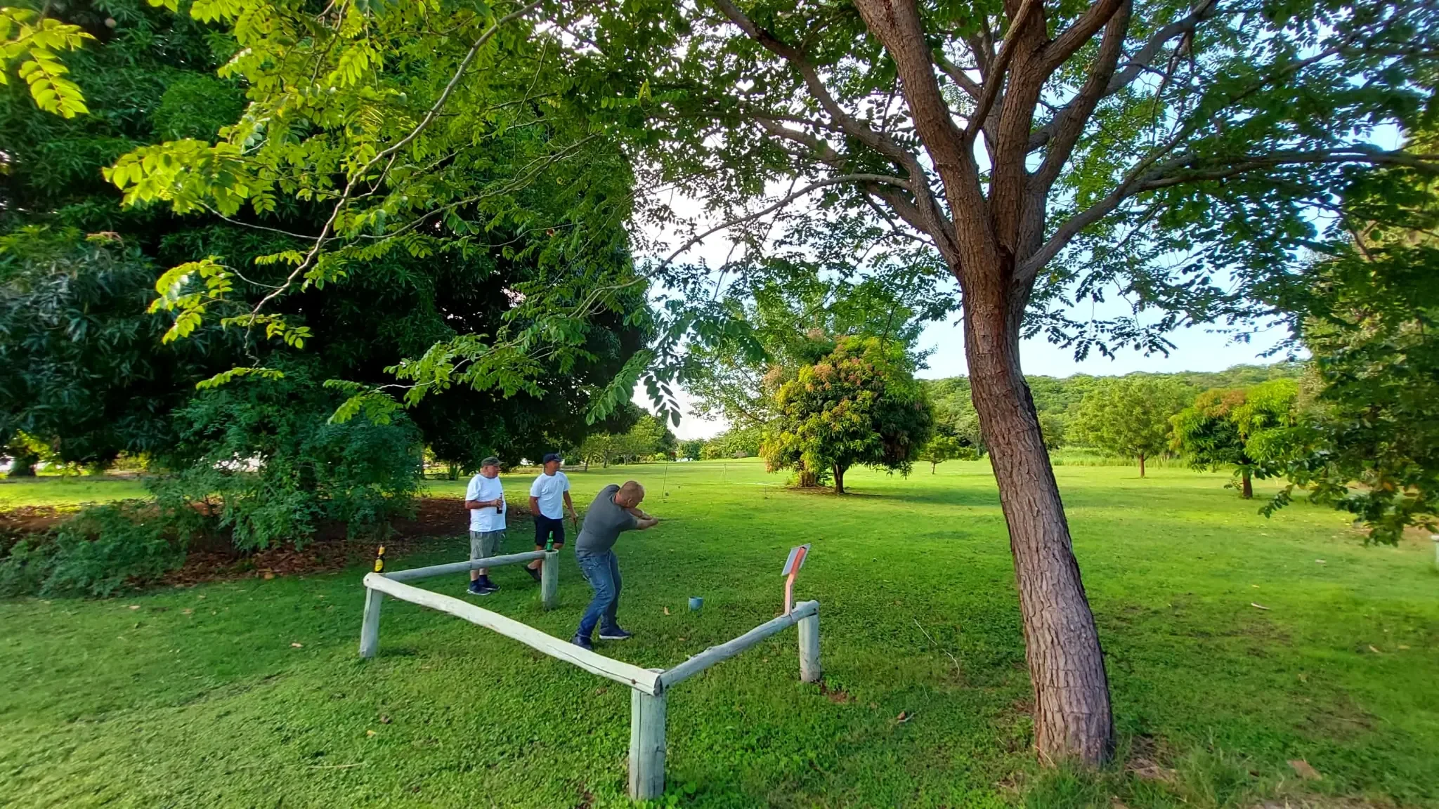 Guests enjoying a casual golf activity on the lush green grounds of Lake Shore Lodge in Kipili, Tanzania, near Lake Tanganyika.