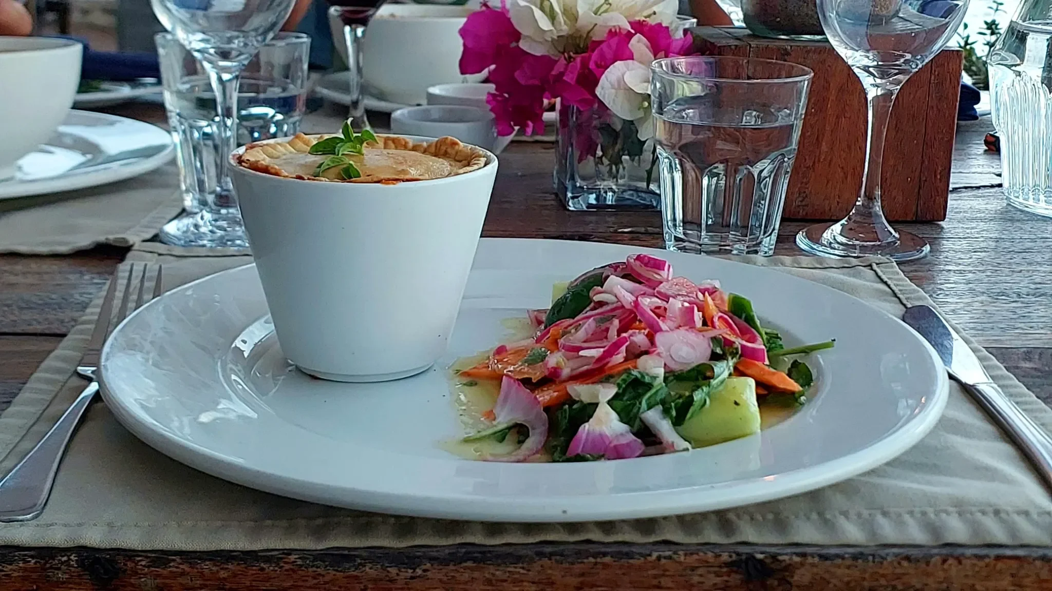 Homemade chicken pie served with a colourful fresh garden salad at Lake Shore Lodge restaurant on Lake Tanganyika, Tanzania.