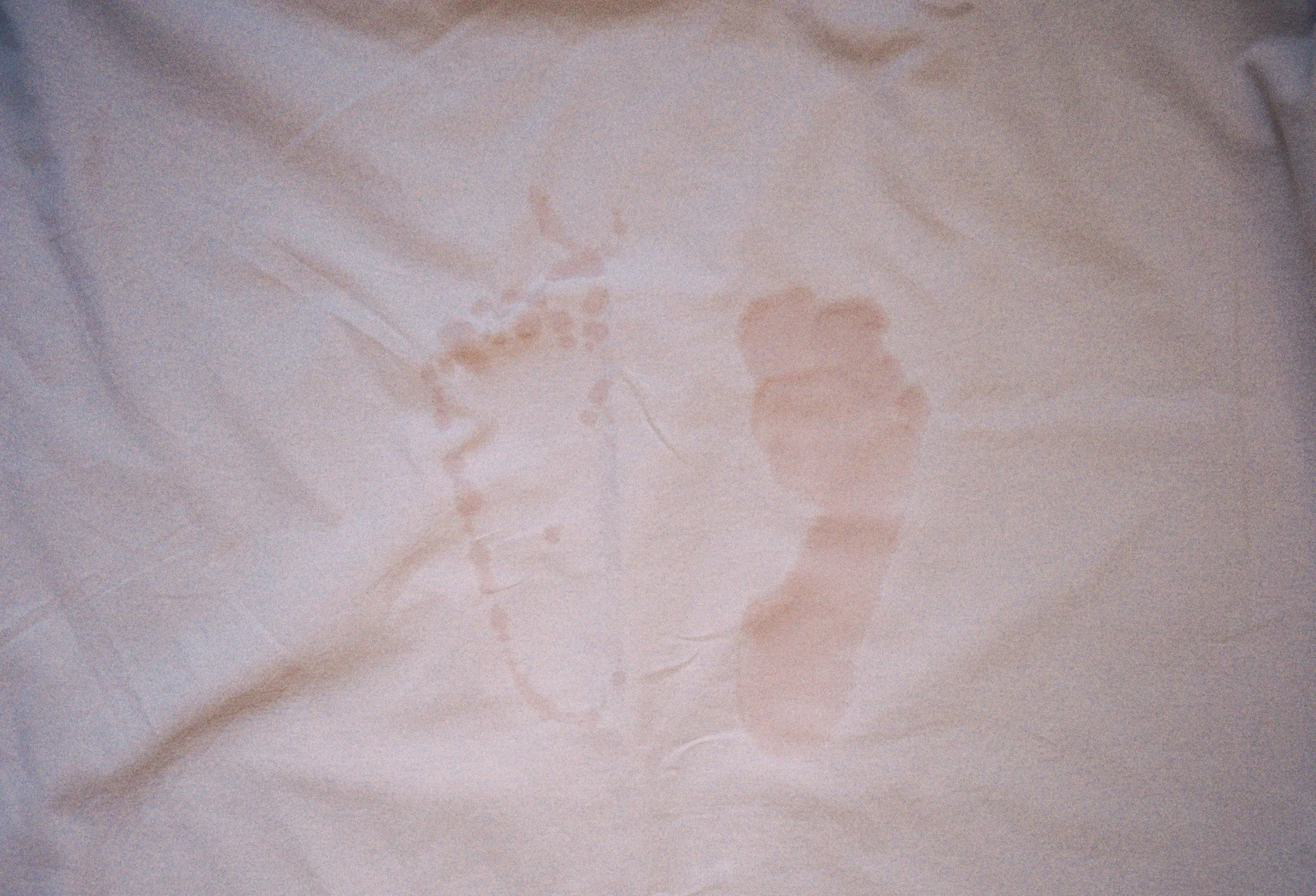 wet feet stain on pink background