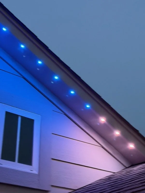 Exterior of a house with colorful LED lights along the eaves