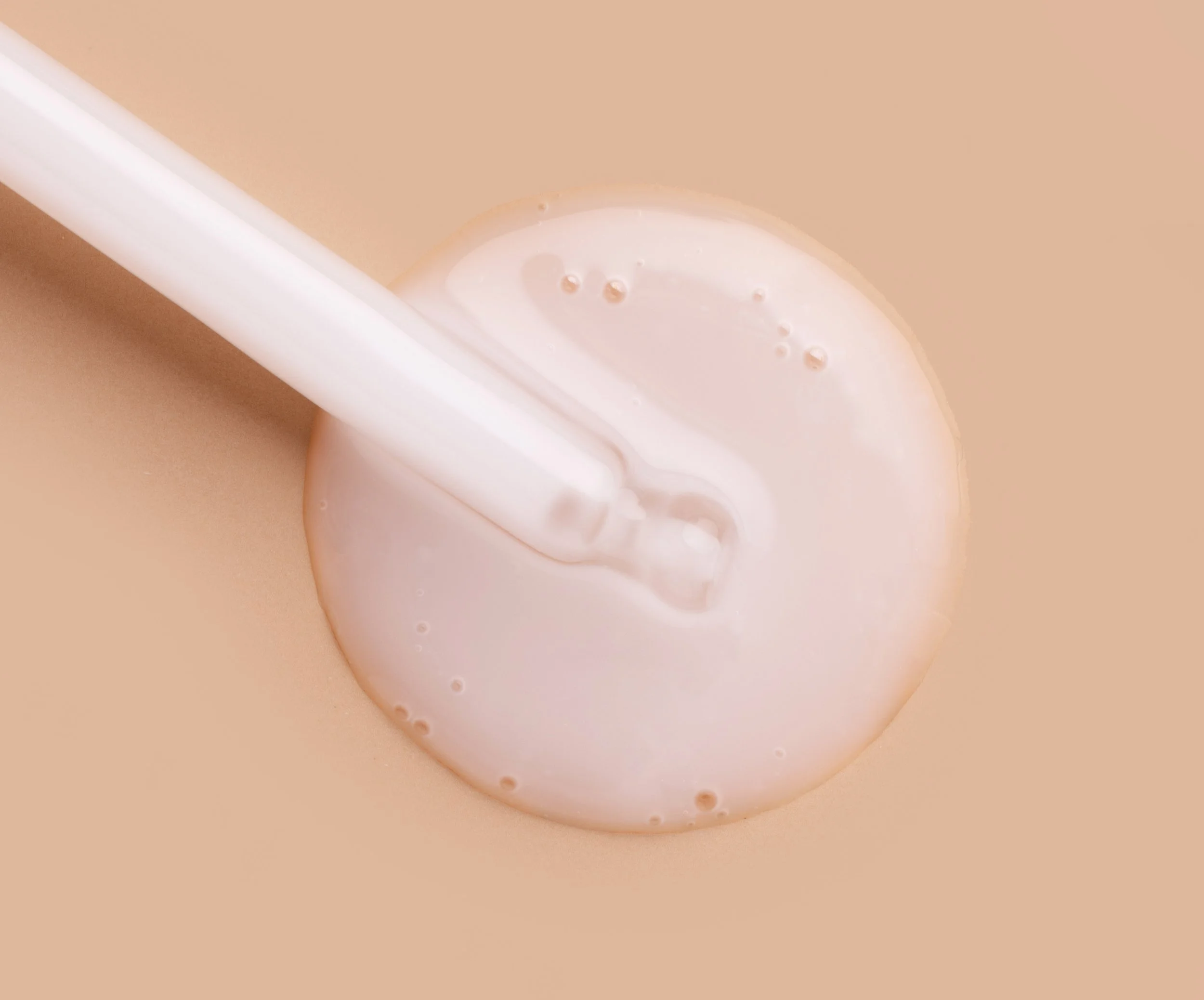 cosmetic-serum-closeup-on-tan-background-2026-03-19-23-26-52-utc.jpg