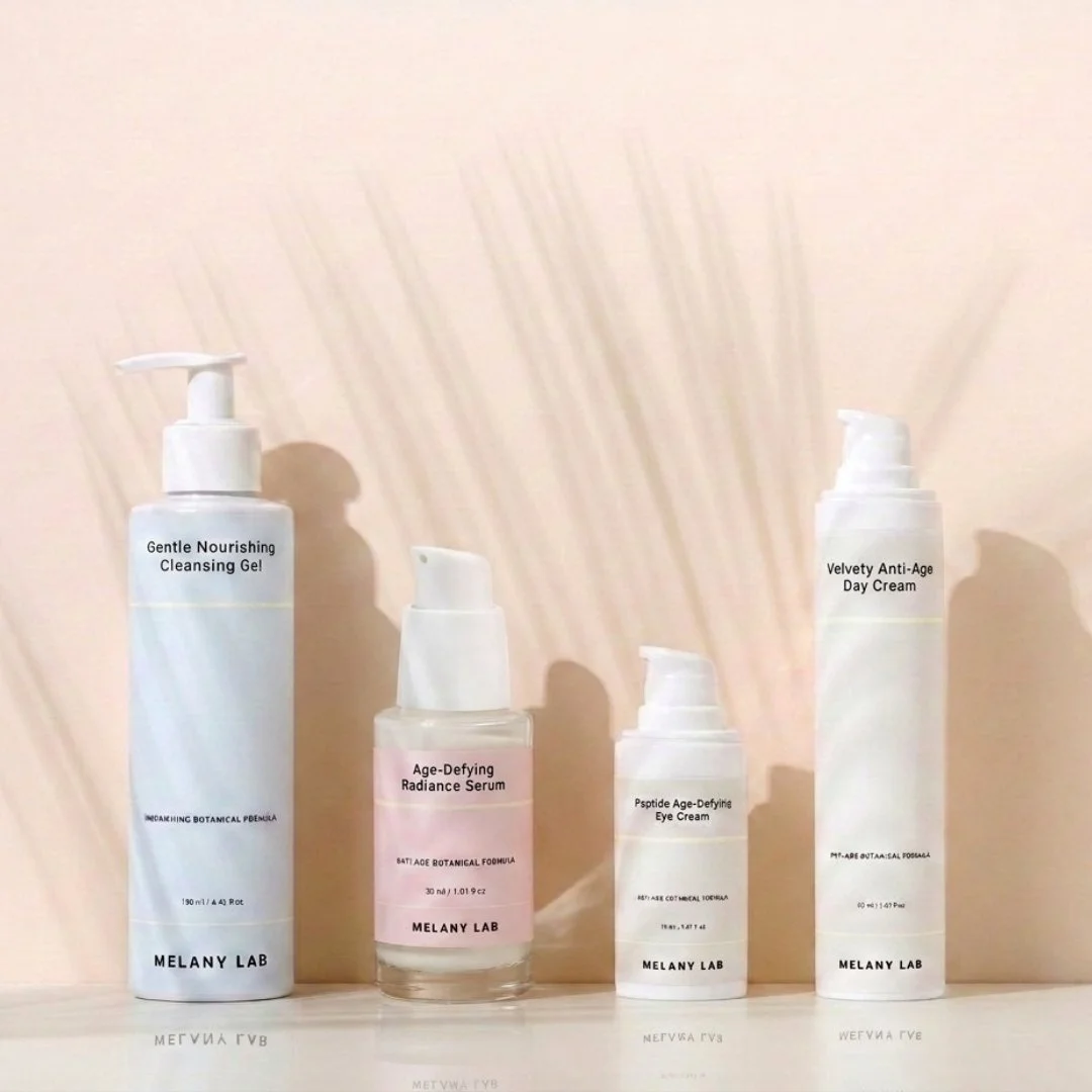 Four skincare bottles on a white surface with a plain light-colored background. The bottles are labeled: Gentle Nourishing Cleansing Gel, Age-Defying Radiance Serum, Psptide Age-Defying Eye Cream, and Velvety Anti-Age Day Cream, all from Melany Lab.