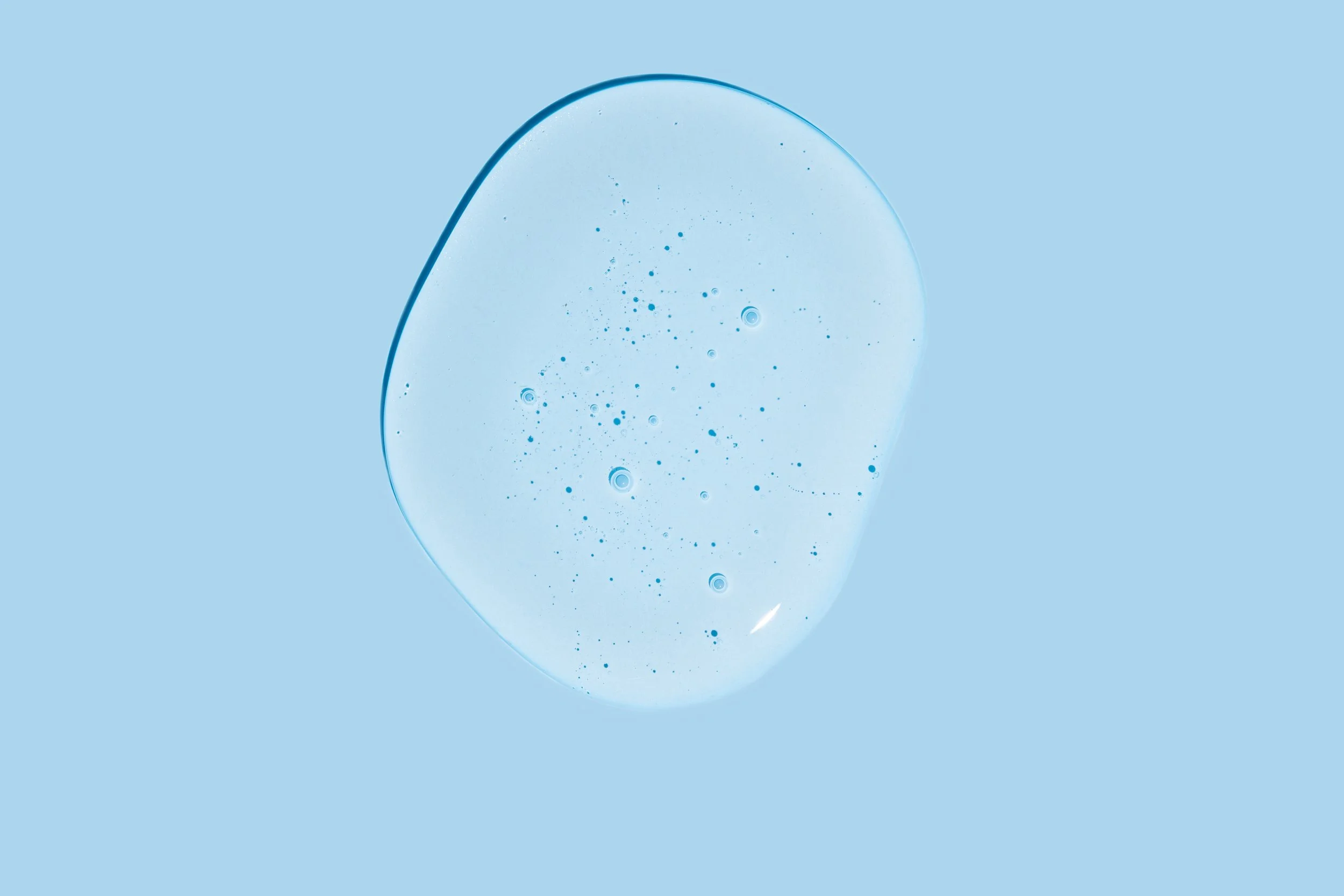 clear-liquid-droplet-on-light-blue-background-2026-03-24-22-42-24-utc.jpg