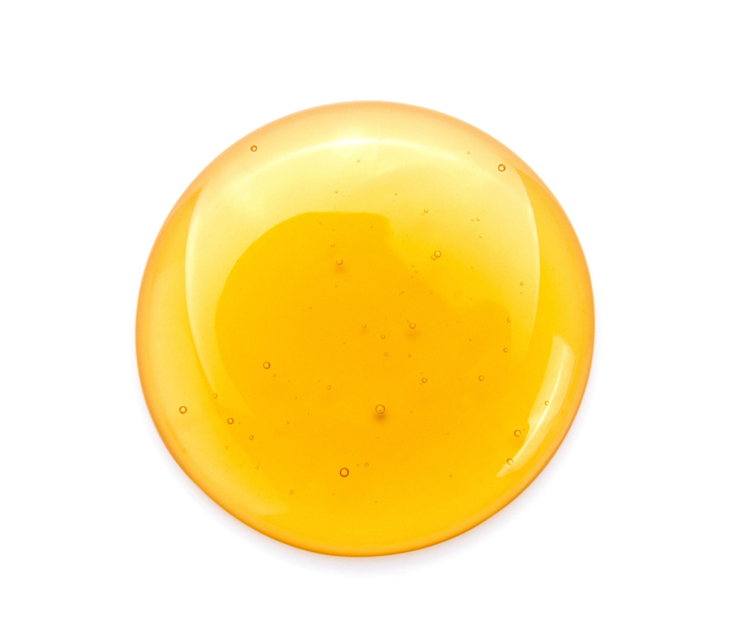 round-golden-honey-drop-on-white-surface-2026-03-10-22-35-10-utc.jpg